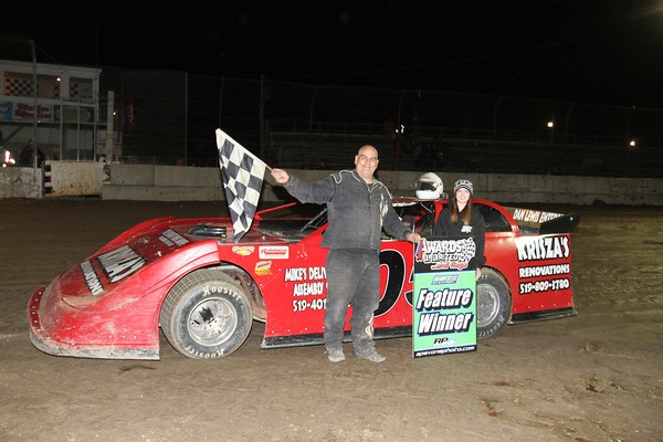 Mike Lewis with flag girl Allie Massender after his first Westside Performance Plus UMP Late Model feature win since 2010 - Photo by James MacDonald/SBR
