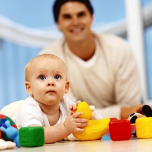 father playing with toys with his baby 6-12 mths