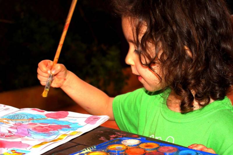 Child painting a watercolor